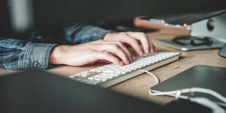 person using computer keyboard